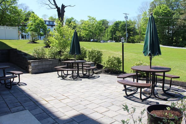 Outdoor patio area with seating and umbrellas