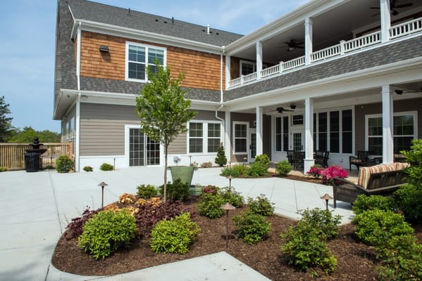 A landscaped outdoor space with seating and flower beds