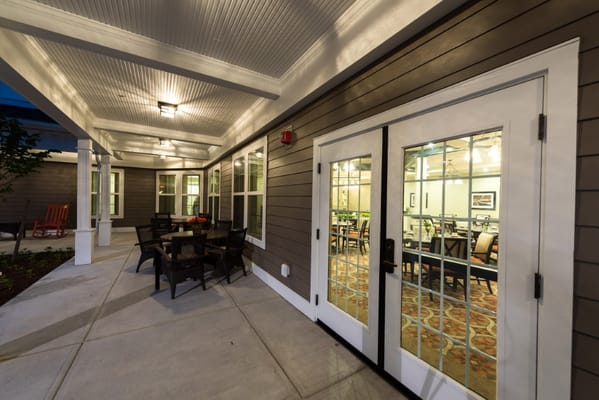 Outdoor patio area leading to a dining room