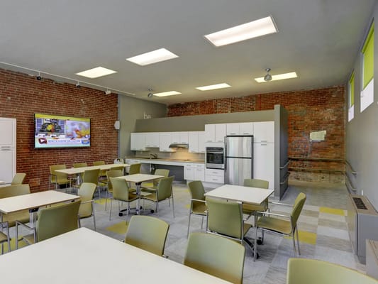 Bright dining area with modern furniture and kitchen appliances