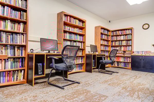 Interior view of a library with bookshelves and computers