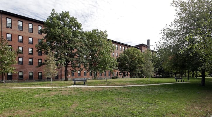 Exterior view of Francis Cabot Lowell Mill surrounded by greenery