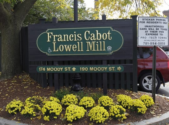 Sign for Francis Cabot Lowell Mill with yellow flowers in front