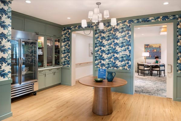 Bright common area with floral decor and residents