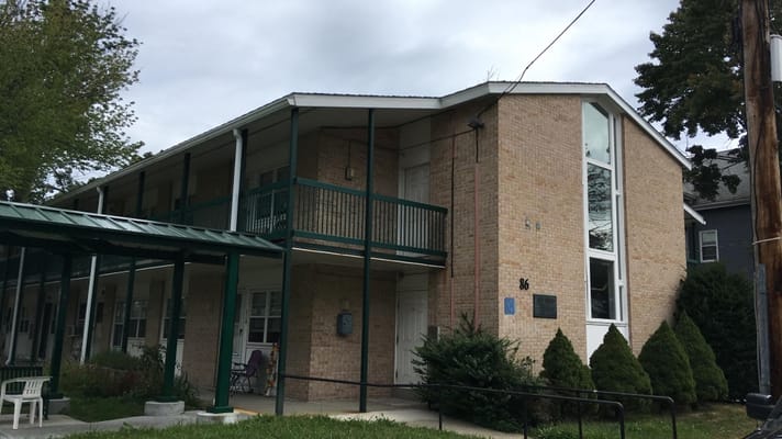 Exterior view of the Orange Street senior living facility showing the entrance and balconies.