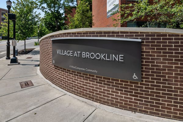 Sign for Village At Brookline senior living facility