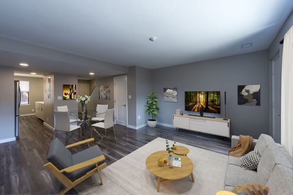 Modern living room with a couch, dining table, and TV.