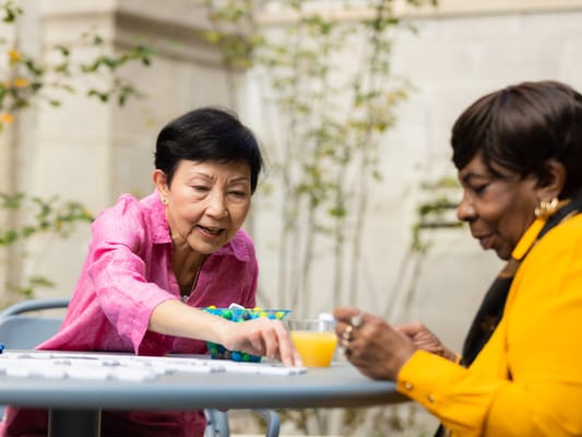 Two residents enjoying a game outdoors
