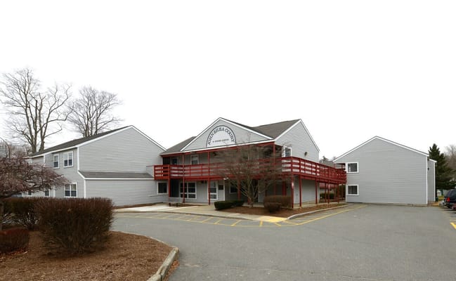 Exterior view of John Shea Court featuring building entrance and parking area