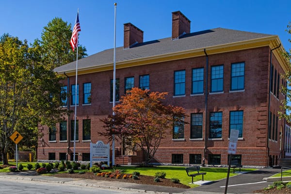 Exterior view of Walker School Apartments with garden.