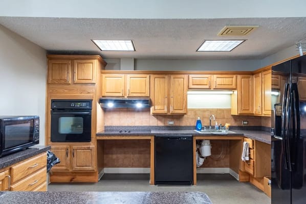 Spacious kitchen with wooden cabinets and appliances