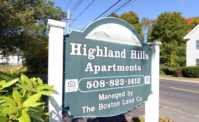 Signage for Highland Hills Apartments with contact information