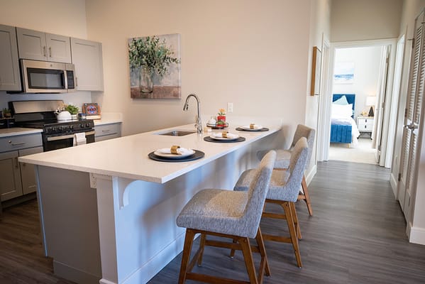 Modern kitchen with dining area in assisted living facility