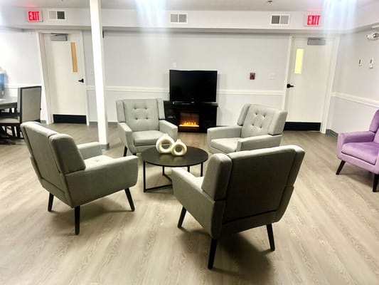 Common area with chairs and TV in a nursing home