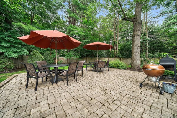 Outdoor patio area with umbrellas and seating