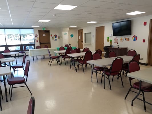 Interior view of a multi-purpose room with tables and chairs