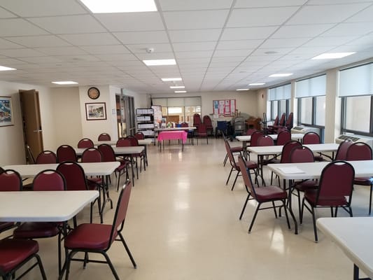 Bright common area with tables and chairs set up