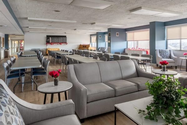 Bright common area with seating and tables