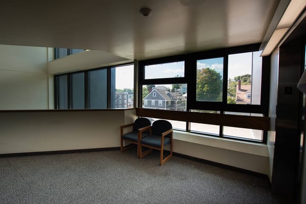 Bright interior space with two chairs and large windows
