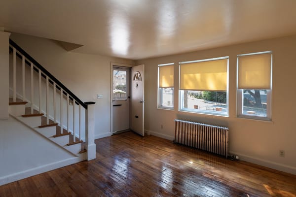 Bright and empty common area with wooden flooring