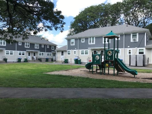 Outdoor playground area with facility buildings in view