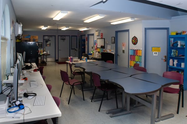 Interior view of a facility common area with tables and chairs