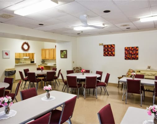 Relaxed dining area with circular tables and floral centerpieces