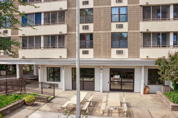Outdoor patio with tables at Canterbury Arms Apartments