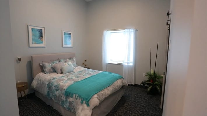 Cozy resident bedroom with decorative bedding and window