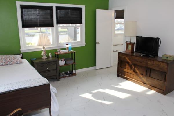 Interior view of a resident room with bed and furniture