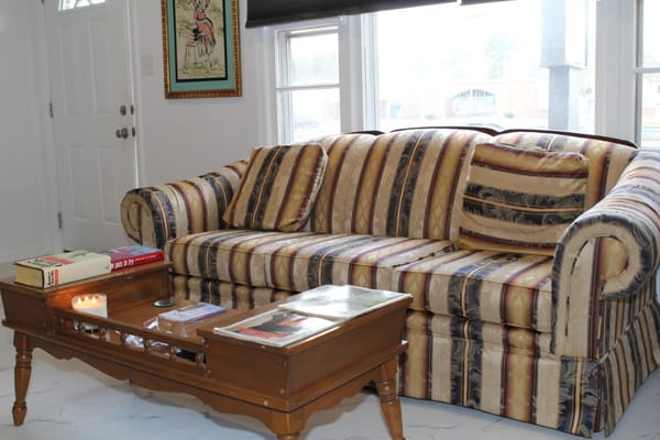 Cozy living room with a striped sofa and coffee table