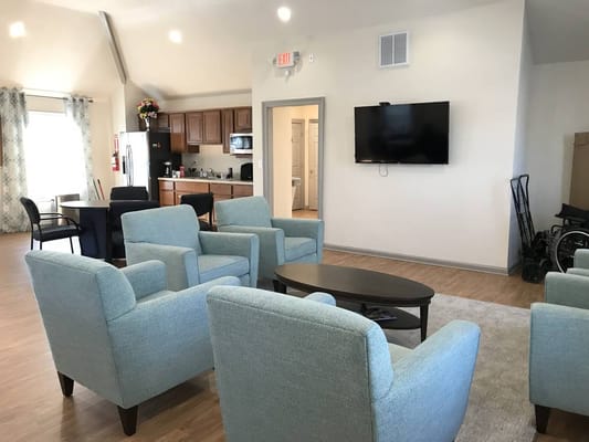 Bright living room with comfortable seating and kitchenette