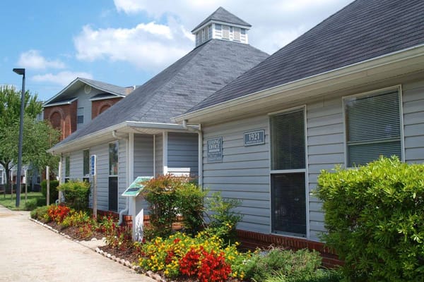 Leasing office building surrounded by colorful flowers at Starling Village