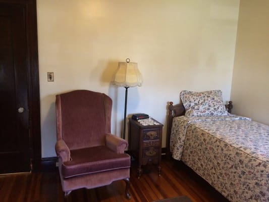 Cozy private room with bed and armchair