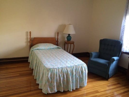 Simple resident room with bed and chair