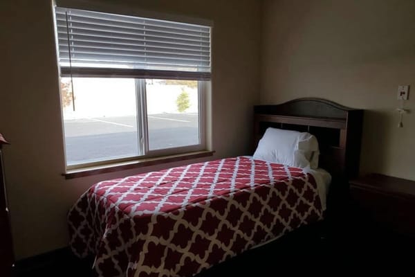 A comfortable bedroom with a bed and window.
