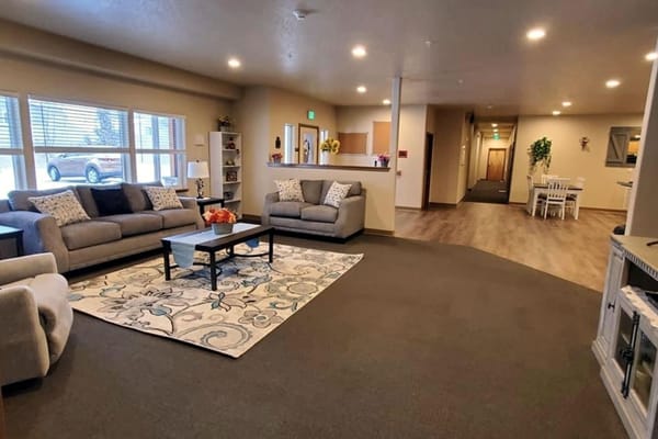 Spacious living room with gray sofas, decorative pillows, and a coffee table