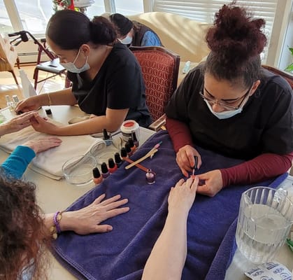 Residents getting manicures in a lively activity.