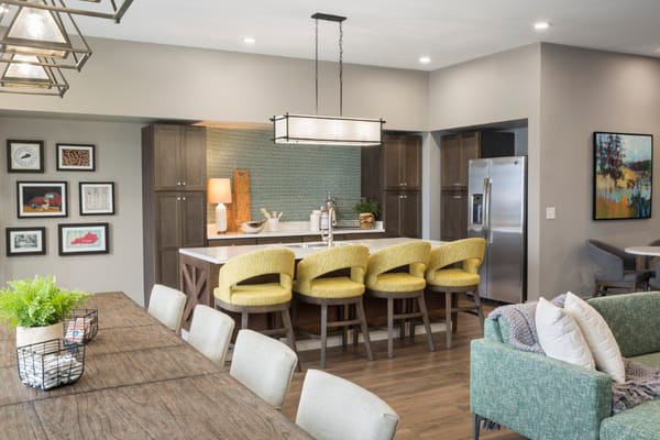 Bright common area with a modern kitchen and seating