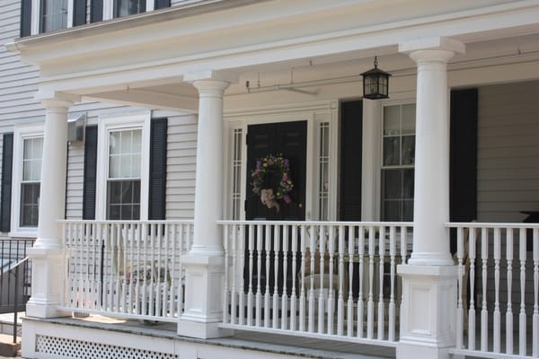 Front porch of Sutton Home for Women with columns and a wreath