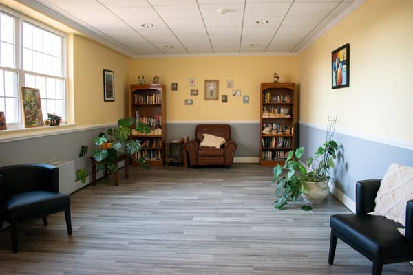 A cozy reading room with books and plants