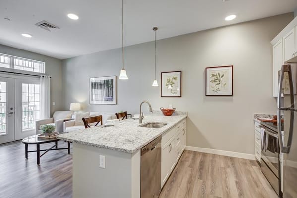 Spacious kitchen with granite countertop and living area with seating