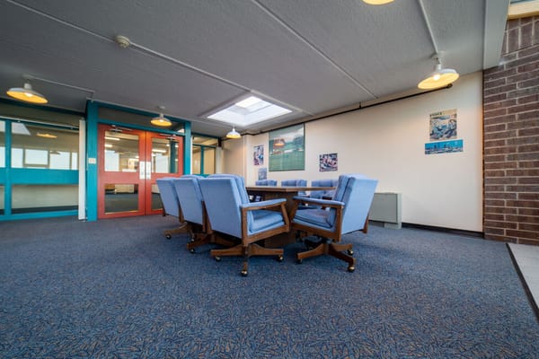 Common area with blue chairs and table in the facility