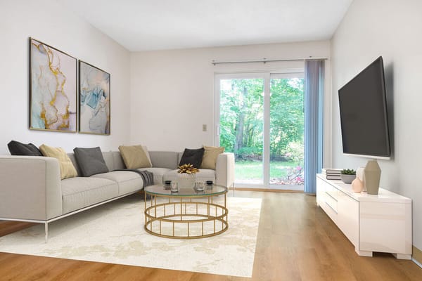 Bright living room with a sofa, coffee table, and sliding doors to the garden