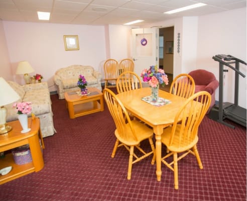 A cozy common area with seating and a dining table at Everett Villa Co-op.