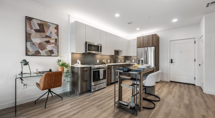 Contemporary kitchen with dining setup and art piece