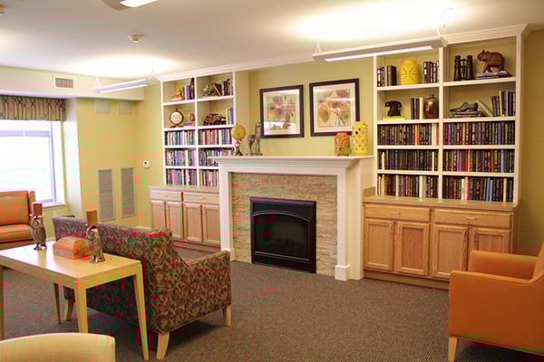 Cozy common room with seating and bookshelves