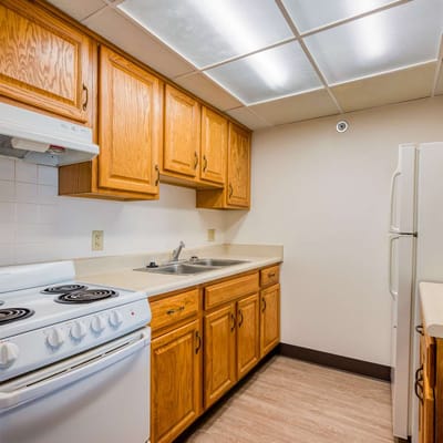 Kitchen area with wooden cabinets and appliances