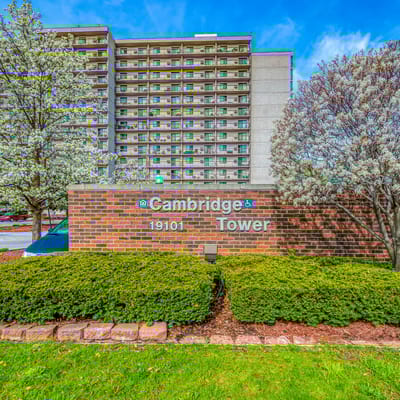 Exterior view of Cambridge Towers with blooming trees