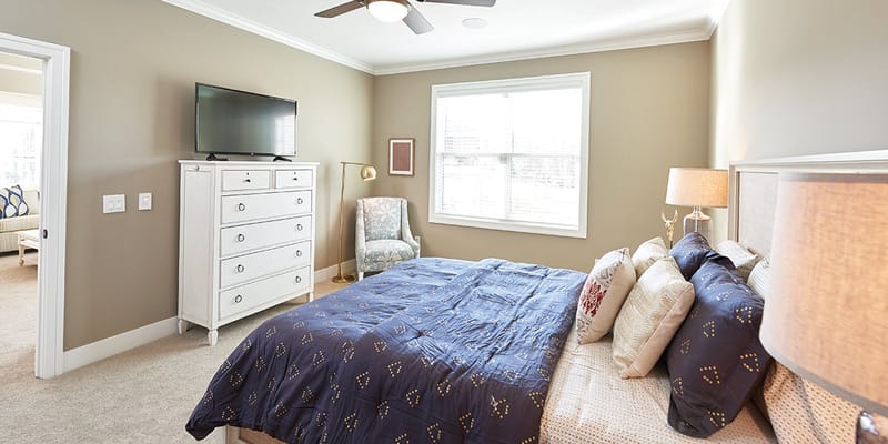 Cozy private resident room with a large bed and TV